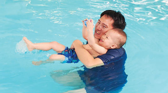 Fathers holding his baby in the water